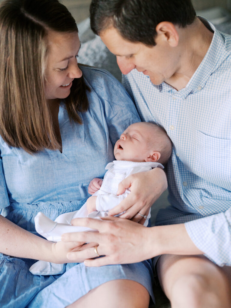 newborn family photos on bed lifestyle session High Point NC